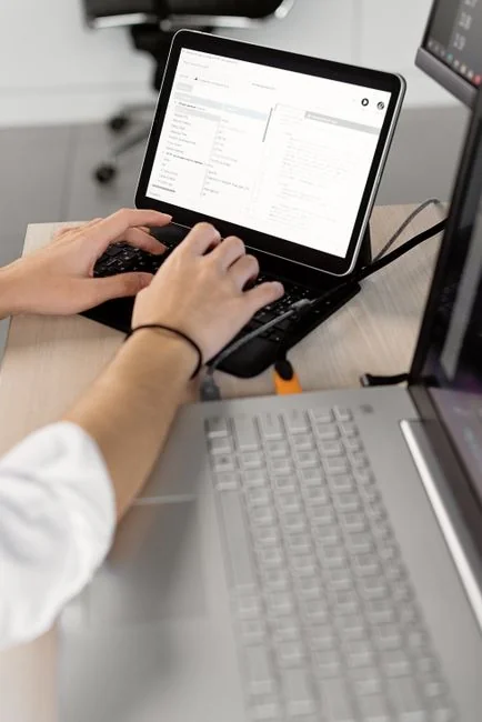 Team members discussing digital graphs on a tablet in a modern office setting.